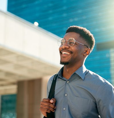 Business, happy and walking black man on city journey, commute trip and real estate agent smile on way to office building. Happiness, career expert and African real estate agent on morning travel in Nigeria
