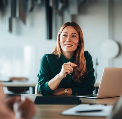 Focus on confident business woman talking to couple. Three entrepreneurs on meeting in board room discussing new agreement. Candidate talking to human resource team during a job interview in the office. Company owner on a meeting with employee. Middle aged businesswoman in a conversation with a colleague. Lawyer or financial advisor consulting clients during formal meeting. Job interview and hiring process.
